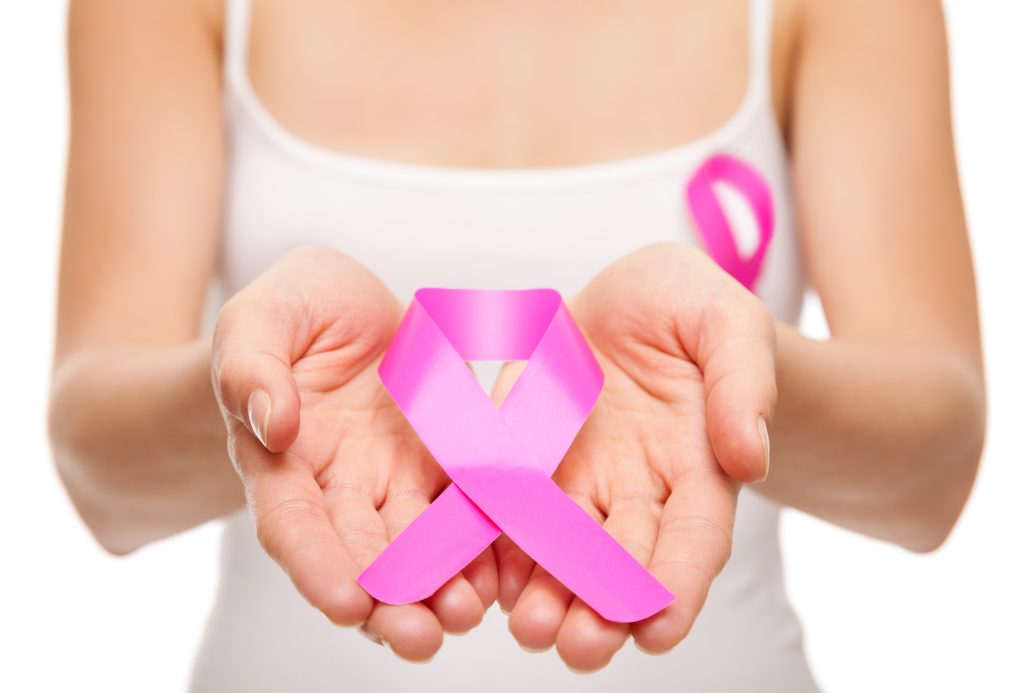 Woman holding a pink cancer awareness ribbon